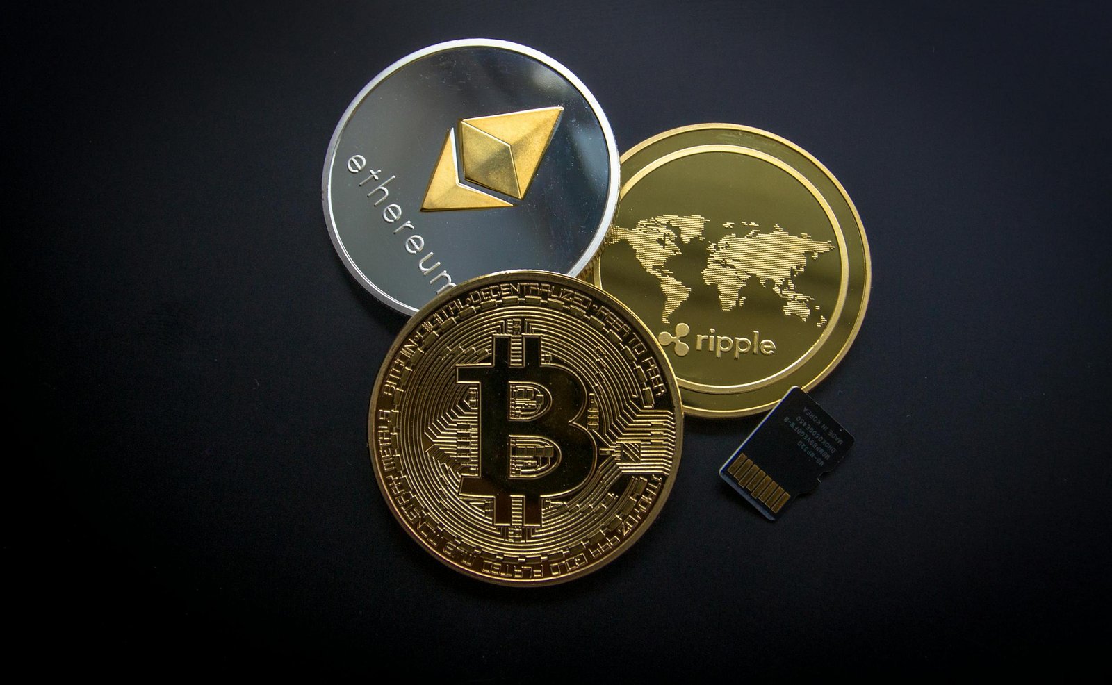 A striking image of Bitcoin, Ethereum, and Ripple coins illustrating modern digital currency.