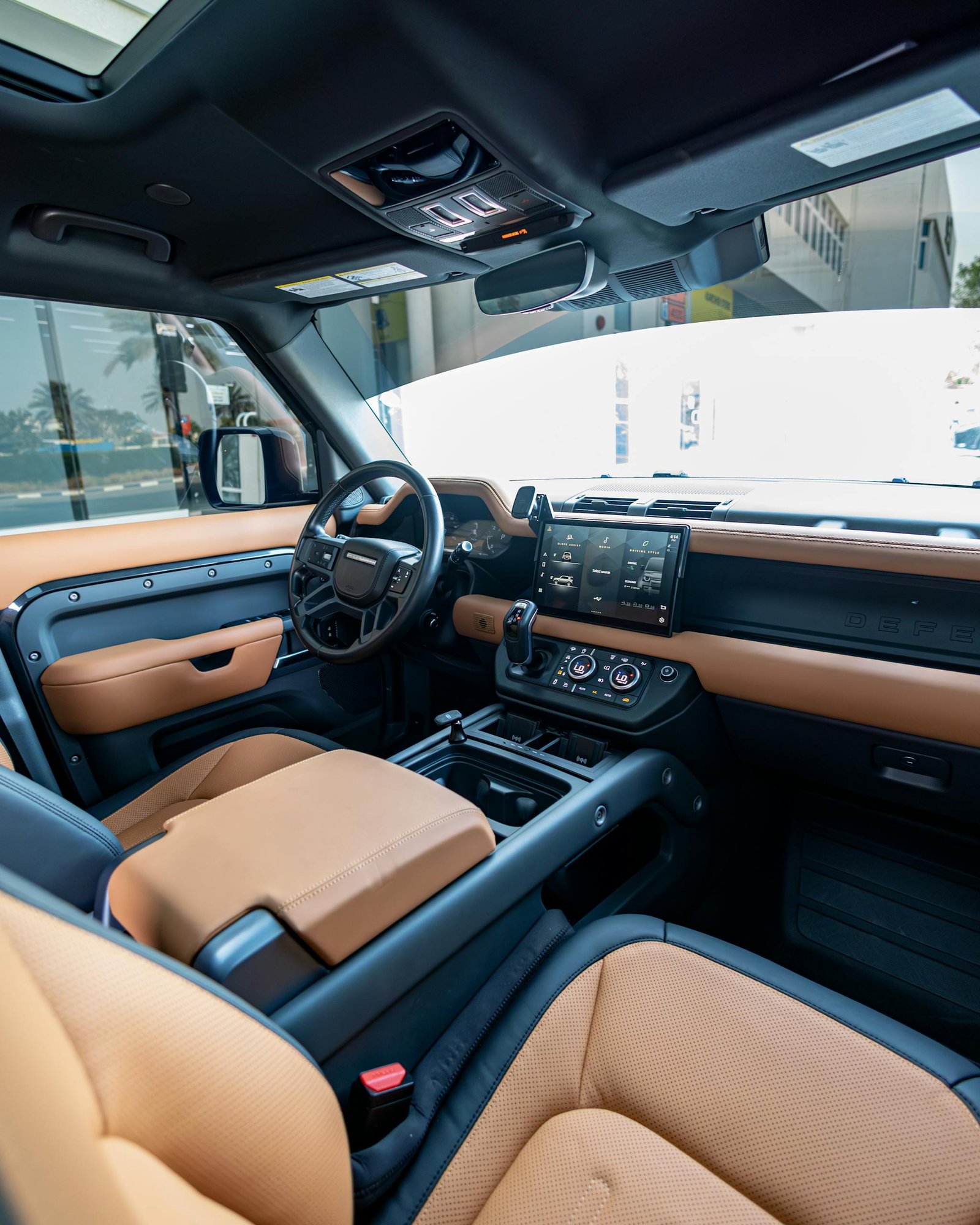 Explore the luxurious leather interior of a modern SUV in Dubai, showcasing high-tech dashboard and spacious seating.